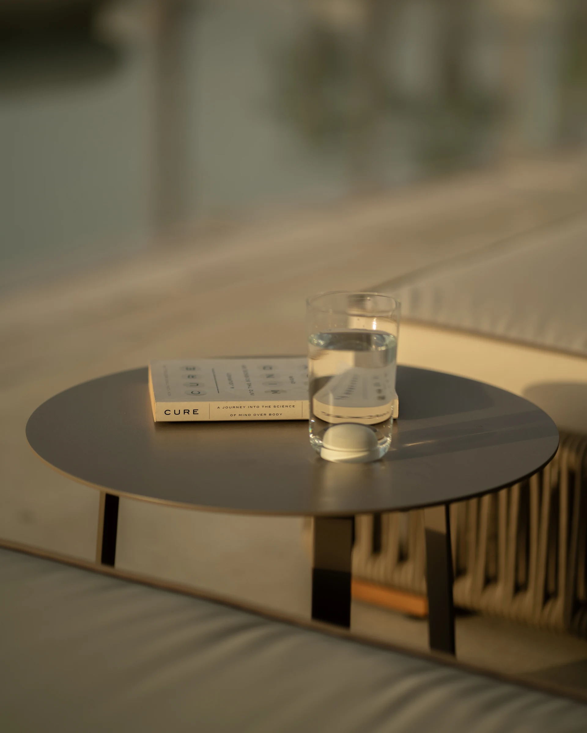 Bedside table with book and water glass
